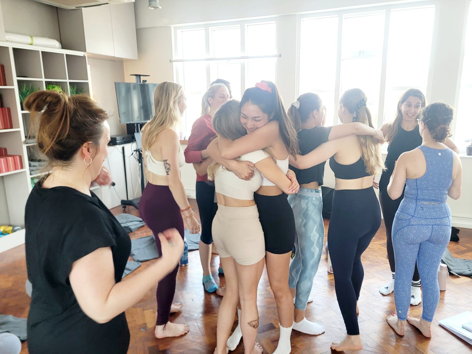 Evoura community members embracing in a circle